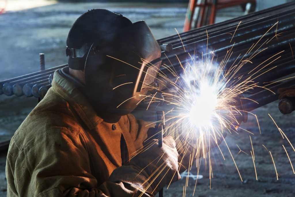 A person arc welding - Arrow Off Road - CNC Manufacturing Company